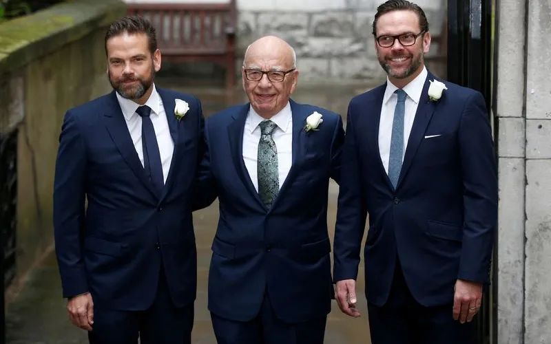 Rupert Murdoch walking in a dark suit, representing the high-stakes family succession battle over his media empire