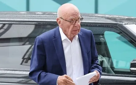 Rupert Murdoch in a dark suit arriving at a courthouse during his family trust legal battle