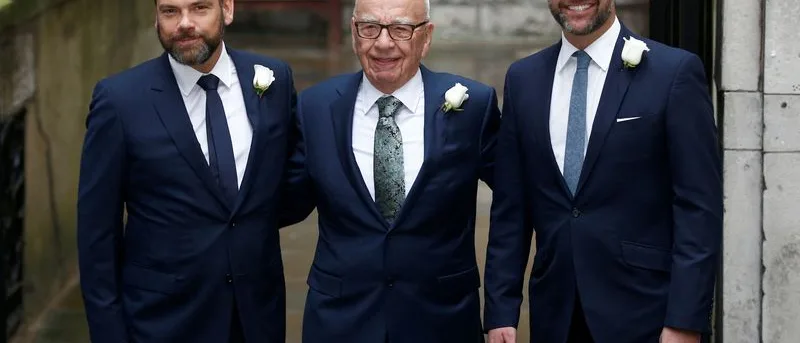 Rupert Murdoch flanked by sons Lachlan and James outside St Bride's church in London