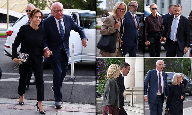 Rupert Murdoch and his wife walking through a crowd of reporters outside a courtroom